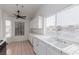 Kitchen with white cabinets, tile floors, and a ceiling fan at 3606 Altar Rock Ln, North Las Vegas, NV 89032