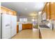 Kitchen features wood cabinets, a dishwasher, and tile floor at 3728 Discovery Creek Ave, North Las Vegas, NV 89031