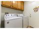 Laundry room with Whirlpool washer and dryer, plus cabinets at 3728 Discovery Creek Ave, North Las Vegas, NV 89031