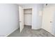 Bright, empty bedroom featuring wall to wall gray carpeting and a closet with an open door at 3790 Desert Marina Dr # 147, Laughlin, NV 89029