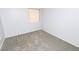 Empty bedroom with gray flooring featuring a window with blinds and white door at 3790 Desert Marina Dr # 147, Laughlin, NV 89029