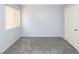 A simple bedroom features gray carpet, light-colored walls and a window covered by blinds at 3790 Desert Marina Dr # 147, Laughlin, NV 89029