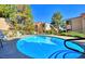 Inviting community pool with clear blue water surrounded by lush landscaping at 3790 Desert Marina Dr # 147, Laughlin, NV 89029
