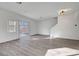 Spacious living room with gray vinyl flooring and sliding glass door at 3929 Pepper Thorn Ave # 101, North Las Vegas, NV 89081