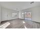 Bright living room featuring vinyl flooring and backyard access at 3929 Pepper Thorn Ave # 101, North Las Vegas, NV 89081