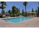 Community swimming pool with lounge chairs and fenced area at 3929 Pepper Thorn Ave # 101, North Las Vegas, NV 89081