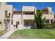 Two-story stucco townhouse with a grassy yard and walkway at 3937 S Torrey Pines Dr, Las Vegas, NV 89103