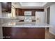 Granite countertops and dark wood cabinets in kitchen at 3937 S Torrey Pines Dr, Las Vegas, NV 89103