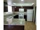 Kitchen boasts granite countertops and white appliances at 3937 S Torrey Pines Dr, Las Vegas, NV 89103