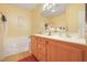 Bathroom featuring double sink vanity with wood cabinets and soaking tub at 3975 N Hualapai Way # 293, Las Vegas, NV 89129