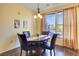 Bright dining room features wood floors and a wooden table with four chairs at 3975 N Hualapai Way # 293, Las Vegas, NV 89129