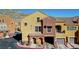 Street view of colorful townhomes with attached garages at 3975 N Hualapai Way # 293, Las Vegas, NV 89129