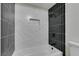 Clean bathroom with black and white tile and a bathtub at 3994 Avonwood Ave, Las Vegas, NV 89121