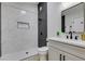 Modern bathroom with marble-look tile, floating vanity, and black fixtures at 3994 Avonwood Ave, Las Vegas, NV 89121