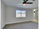 Bright bedroom with grey carpet, ceiling fan and window at 3994 Avonwood Ave, Las Vegas, NV 89121