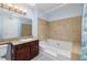 Clean bathroom with a soaking tub, shower, and granite vanity at 4050 Pacific Harbors Dr # 246, Las Vegas, NV 89121