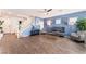 Spacious living room with hardwood floors, gray couch, and blue walls at 4129 Chamisa Cove St, Las Vegas, NV 89115