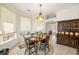 Bright breakfast nook features a round table and chairs, built-in hutch, and large windows at 4351 W Bell Vista Ave, Pahrump, NV 89060