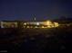 Night view of a single-story home with a lit yard and desert landscape at 4351 W Bell Vista Ave, Pahrump, NV 89060