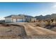 Single story home with a three car garage and landscaped yard at 4351 W Bell Vista Ave, Pahrump, NV 89060