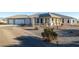 Single-story home with a three-car garage and desert landscaping at 4351 W Bell Vista Ave, Pahrump, NV 89060