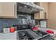 Modern gas cooktop with updated backsplash and range hood at 4431 El Cebra Way, Las Vegas, NV 89121