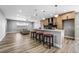 Open concept kitchen with island and view into living room at 4431 El Cebra Way, Las Vegas, NV 89121