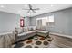 Living room with L-shaped sofa and large window at 4431 El Cebra Way, Las Vegas, NV 89121