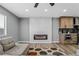 Living area with an electric fireplace and built-in shelving at 4431 El Cebra Way, Las Vegas, NV 89121