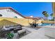 Open-air patio with comfortable seating, a dining set, and view of the inviting swimming pool and landscaped yard at 4532 Laguna Vista St, Las Vegas, NV 89147