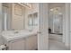 Bright bathroom featuring double sinks and a doorway leading to the hallway at 4532 Laguna Vista St, Las Vegas, NV 89147