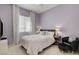 Serene bedroom with lilac walls, white bedding, and sheer curtains for soft natural light at 4532 Laguna Vista St, Las Vegas, NV 89147