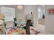 Modern dining room with glass table, chandelier, and view into kitchen at 4532 Laguna Vista St, Las Vegas, NV 89147