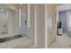 Bright hallway featuring tile flooring, white walls, and doorway leading to bedroom at 4532 Laguna Vista St, Las Vegas, NV 89147