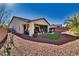 Exterior view of the home featuring a covered patio and landscaped backyard at 5170 Agio Ave, Pahrump, NV 89061