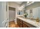 Double vanity bathroom with granite countertops and hardwood floors at 5170 Agio Ave, Pahrump, NV 89061