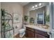 Half bath with decorative mirror, granite counters, hardwood floors, and a decorative shelf at 5170 Agio Ave, Pahrump, NV 89061