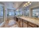 Bathroom featuring double sinks, marble countertops, walk-in shower and separate tub at 5170 Agio Ave, Pahrump, NV 89061