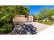 Multi-car garage with brick-paved driveway surrounded by trees and colorful landscaping at 5170 Agio Ave, Pahrump, NV 89061