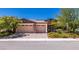 Charming single-Gathering home showcasing a multi-car garage and colorful, mature landscaping at 5170 Agio Ave, Pahrump, NV 89061