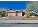 Single-story home with three-car garage and landscaped front yard at 5170 Agio Ave, Pahrump, NV 89061