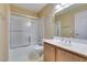 Clean bathroom with a shower/tub combo, vanity with mirror, and wood cabinets at 5340 Silvermist Ct # 103, Las Vegas, NV 89122