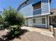 Charming exterior of a two-story townhouse with blue siding and a well-manicured front yard at 5340 Silvermist Ct # 103, Las Vegas, NV 89122
