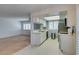 Bright kitchen featuring white cabinets, stainless steel appliances, and tile flooring, open to the living area at 5340 Silvermist Ct # 103, Las Vegas, NV 89122