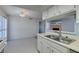 Kitchen featuring a double sink, white appliances, and tile flooring, offering a view into the living and dining areas at 5340 Silvermist Ct # 103, Las Vegas, NV 89122