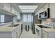 Well-lit kitchen with stainless steel appliances, white cabinets, and tile flooring and a stainless steel trash can at 5340 Silvermist Ct # 103, Las Vegas, NV 89122