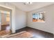 Spacious bedroom featuring hardwood floors, a window, and an open doorway, creating a comfortable living space at 5453 Requa Ave, Las Vegas, NV 89110