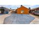 Orange house with a large driveway and small front yard at 5453 Requa Ave, Las Vegas, NV 89110