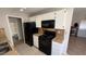 Kitchen boasts white cabinets, black appliances, and tile floors at 5453 Requa Ave, Las Vegas, NV 89110