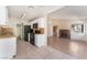 A view of the kitchen with black appliances that leads to the living room and fireplace at 5453 Requa Ave, Las Vegas, NV 89110